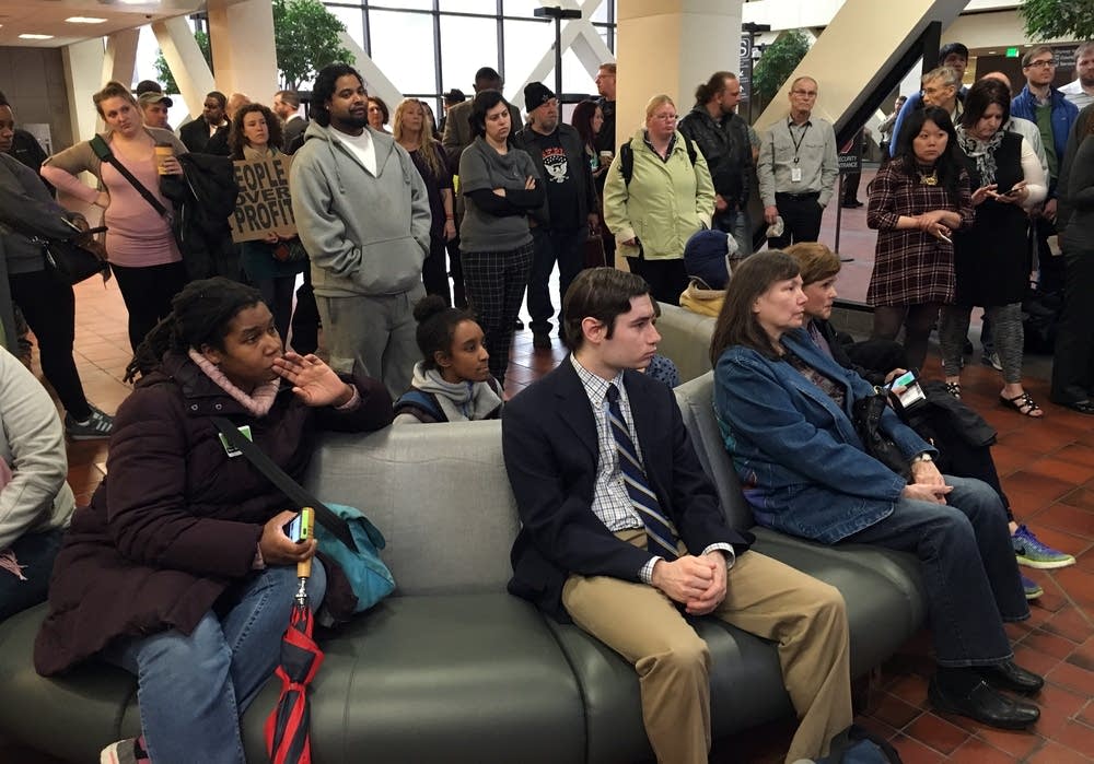 People watch the press conference.