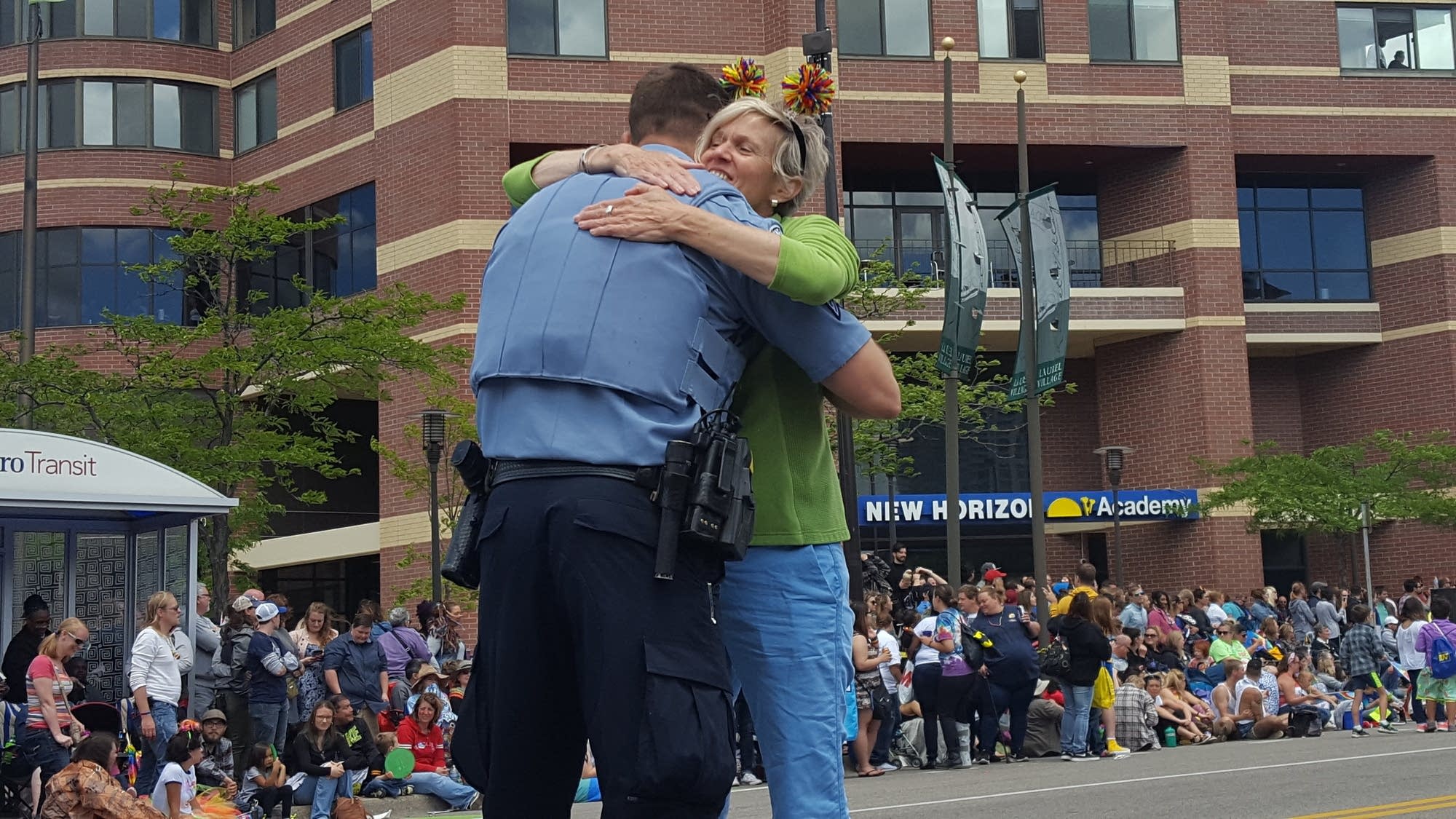 A Pride attendee hugs Minneapolis Polcie Sgt. Deitan Dubuc.