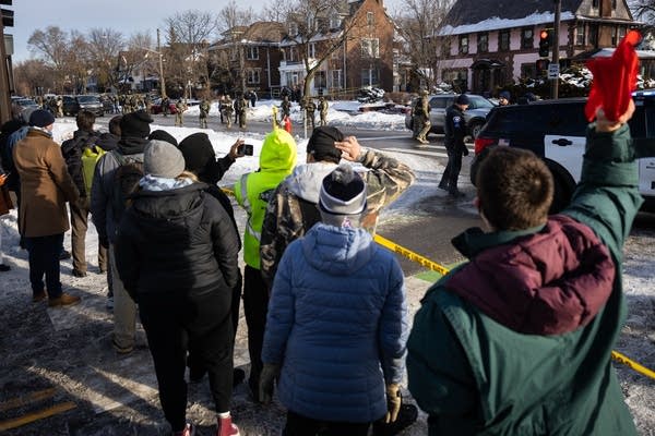 A crowd shouts at federal officers