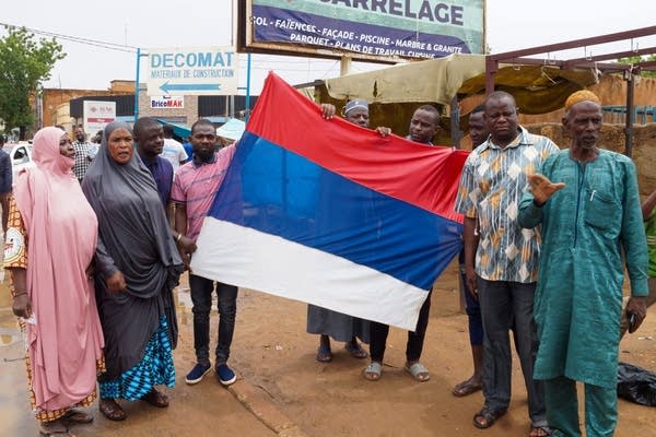 Coup supporters unfurl a Russian flag as they take to the streets after the army seized power in Niamey, Niger on July 27, 2023. 