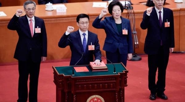 Newly elected Vice Premiers Hu Chunhua (L), Sun Chunlan (2nd R) and Liu He (R), led by Han Zheng (2nd L), take an oath after being elected during the seventh plenary session of the first session of the 13th National People's Congress (NPC) at the Great Hall of the People in Beijing on March 19, 2018.