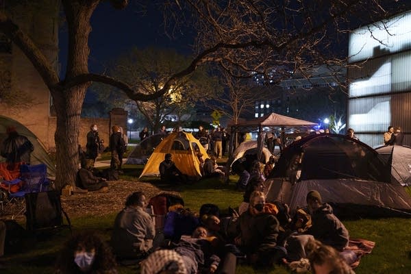 a group of people gather around tents