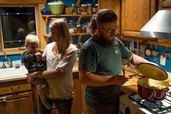 Yvette Ibrahim holds Zein while her husband, Tamer, heats up dinner.