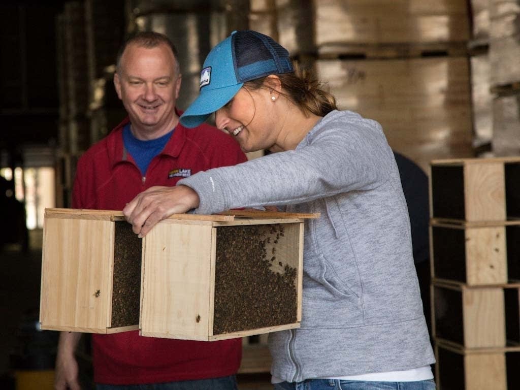 Patrick Montague from Mann Lake hands over a set of bee crates.
