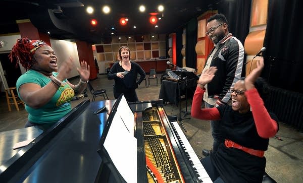 Composer Dameun Strange, second from right, laughs with performers.