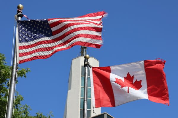 American and Canadian flag flying side by side