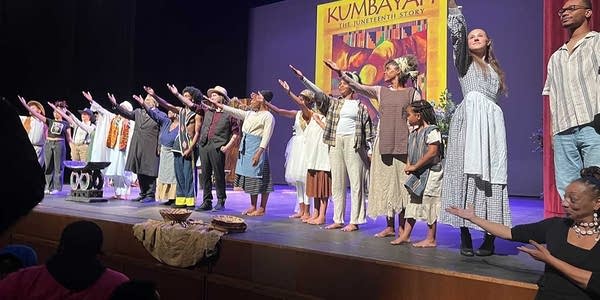 People perform on a stage for Juneteenth