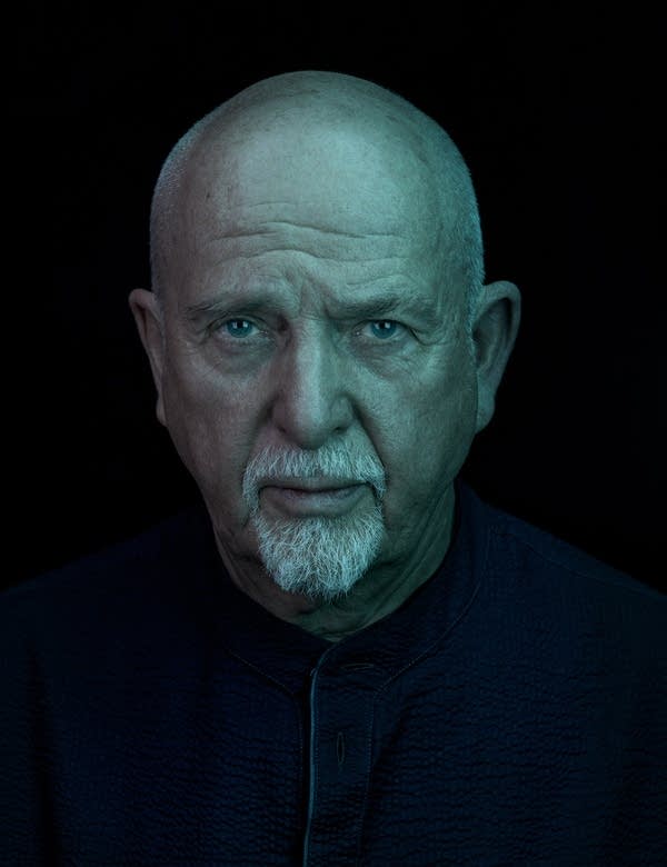 Close-up portrait of a bald man with a moustache and goatee