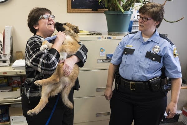 St. Paul Police Department employee Angela Anderson snuggles Sergeant Fuzz.