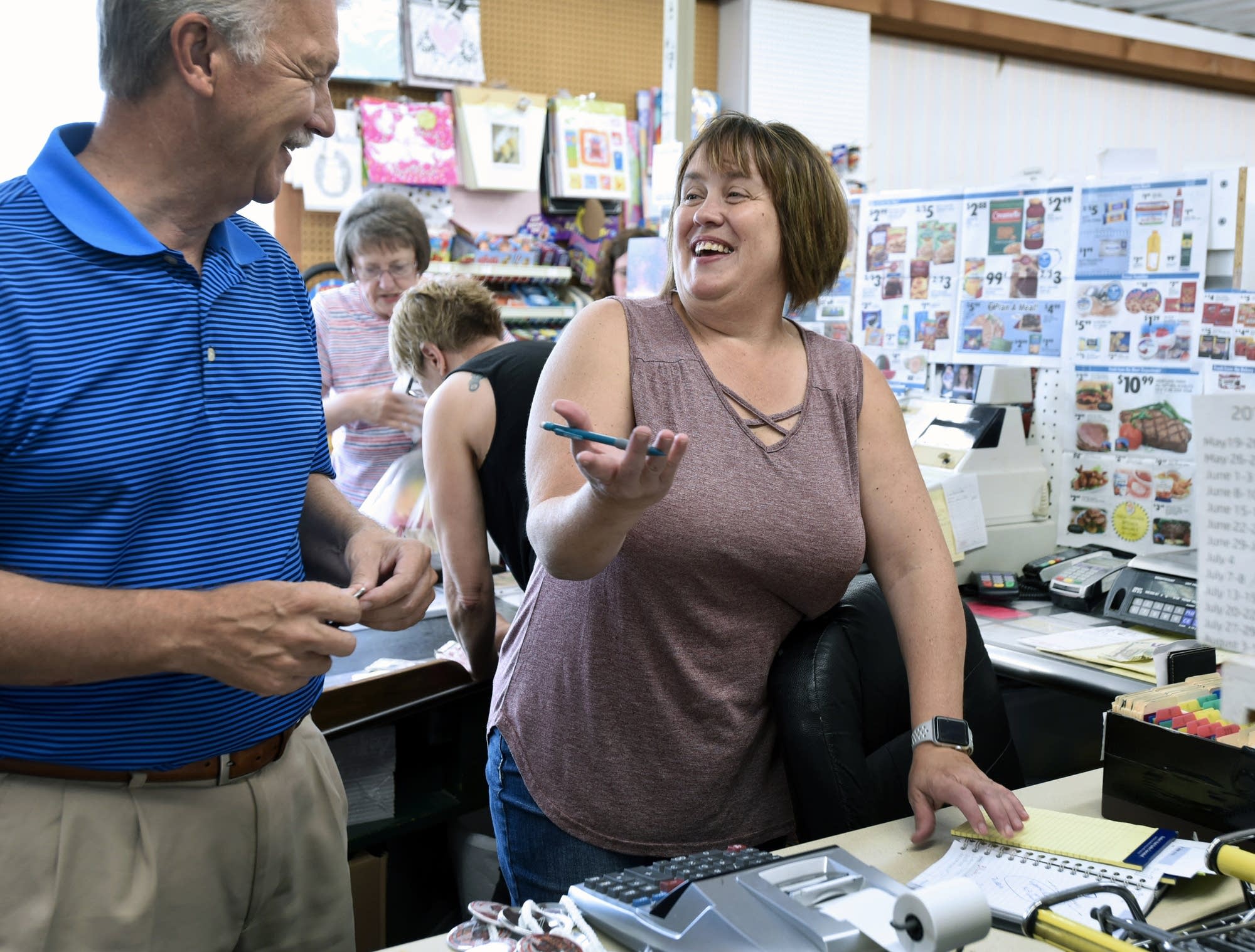 Bonnie Carlson visits with a customer in her store in Clinton, Minn.