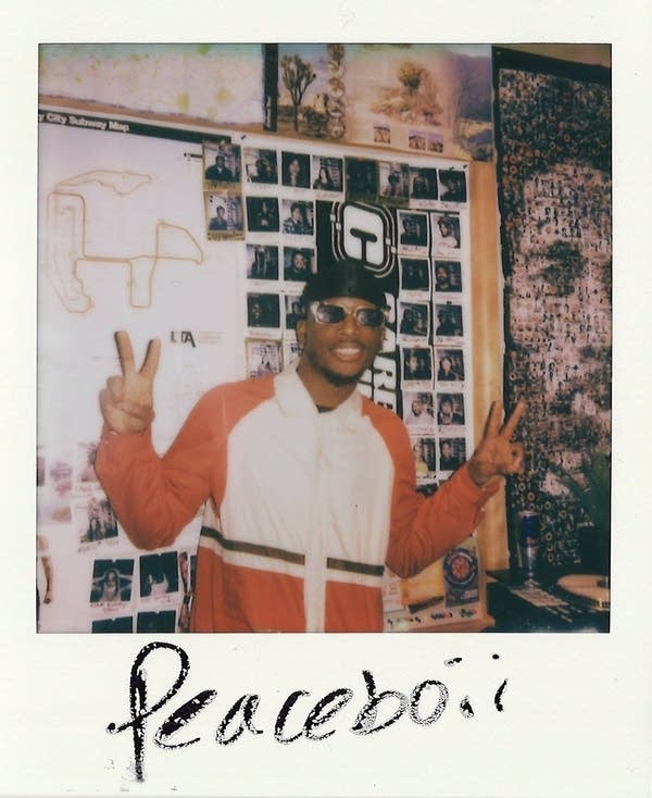 DJ PEACEBOII posing for a polaroid photo