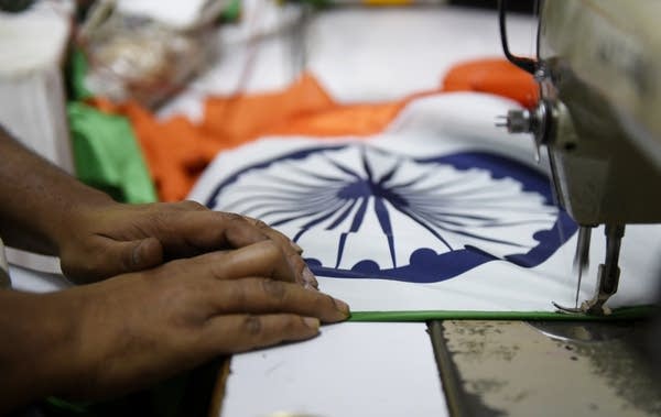 A man makes flags in Mumbai, India, on 23 January 2019 before Indian Republic day i.e., 26th of January 2019.