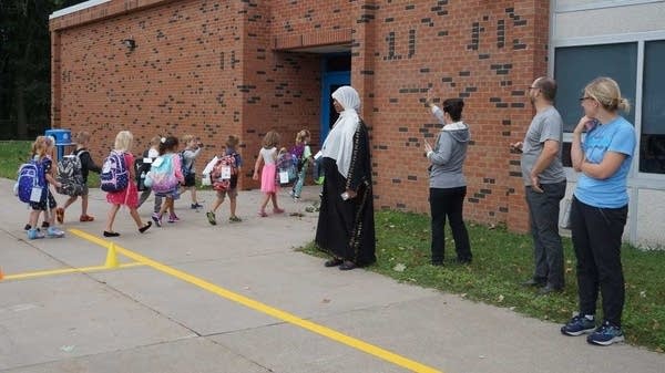 Students go to school on the first day of the new school year.