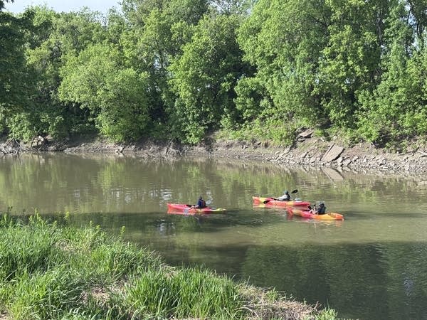 Three kayaks on a river
