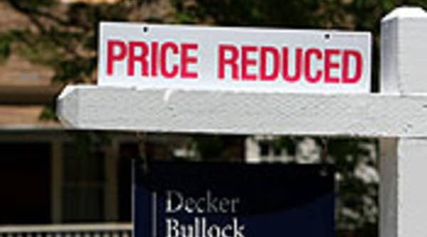 A realtor sign advertises a reduced price in front of a home for sale in San Anselmo, Calif.