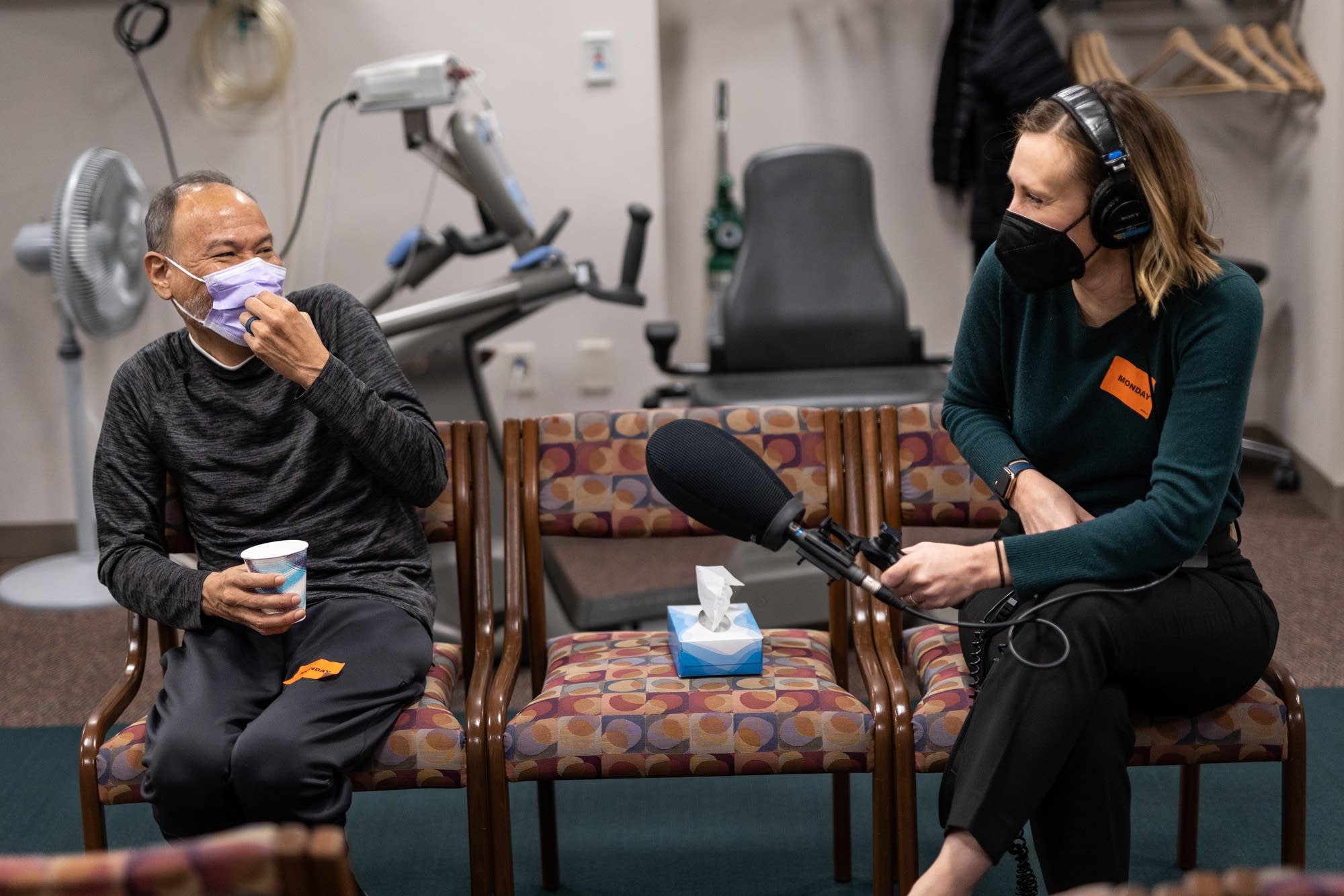 Two people talk with a microphone between them