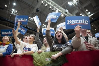 A crowd of Bernie Sanders supporters cheers 