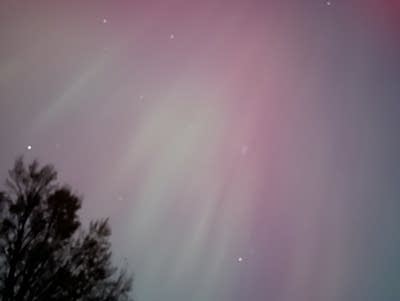 Green and red lights in the night sky.