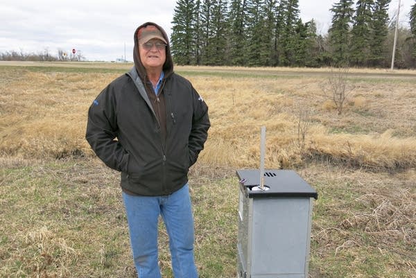 Gerry Zimmerman stands near drainage control.