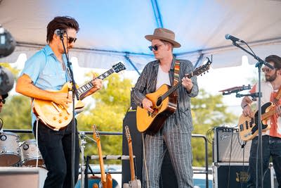 A band performing on an outdoor stage