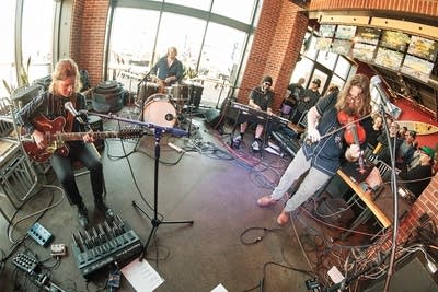 Four musicians performing in a taproom