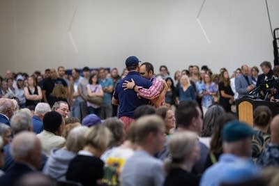 Two people embrace