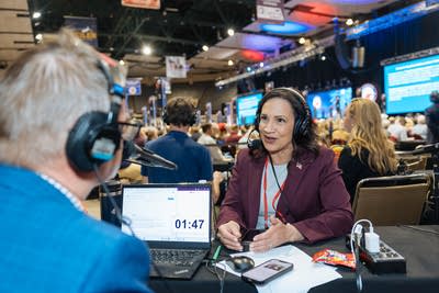 A woman sits for an interview on the radio.