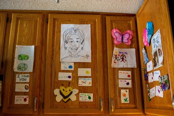 Photos and art are displayed on cabinet doors.
