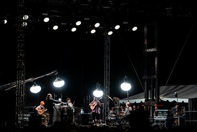 Dijon performing on an outdoor stage.