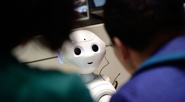 The robot 'Pepper' speaks with visitors at the IBM stand at the CeBIT 2017 Technology Trade Fair on March 20, 2017 in Hanover, Germany.
