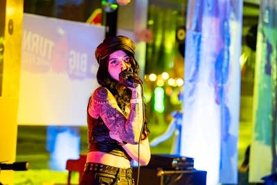 A musician sings onstage in a nontraditional music venue