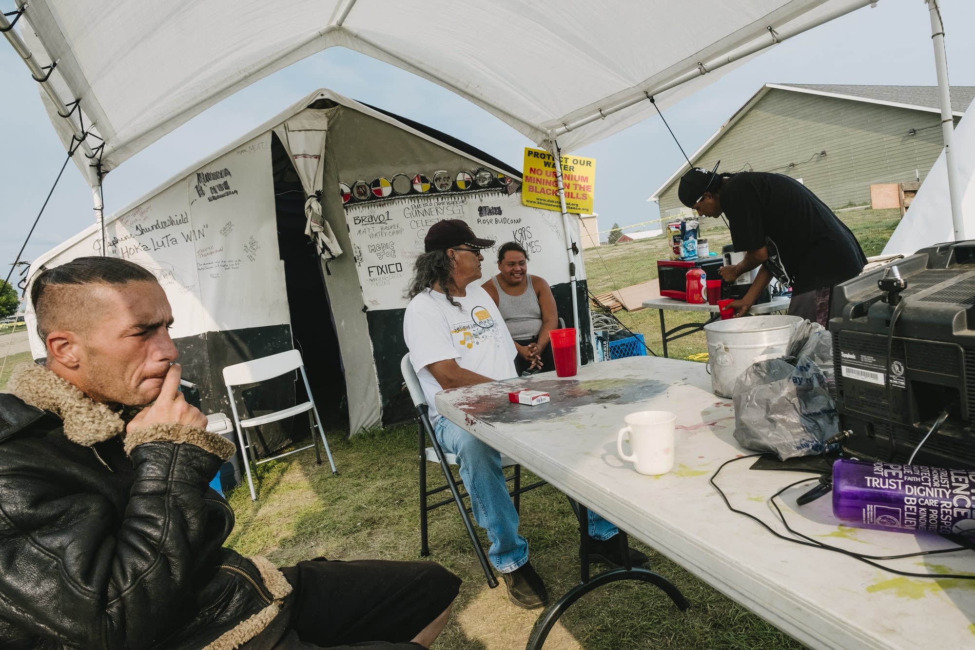 Men gather for coffee at the Eagle Butte Camp.
