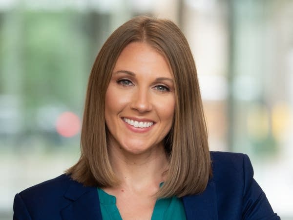 A woman poses for a professional photograph.