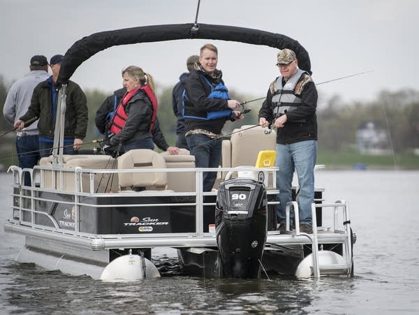 Gov. Tim Walz (right) and legislative leaders fish