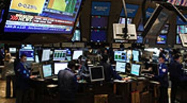 Traders work on the floor of the New York Stock Exchange as the Federal Reserve announces that it will be keeping its key interest rate near zero in New York.