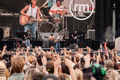 A band perforning on a large outdoor stage