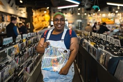 Person holding record and smiling