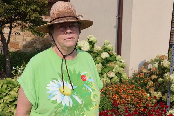 A woman stands outside of a building.