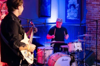 Guitarist looking at drummer