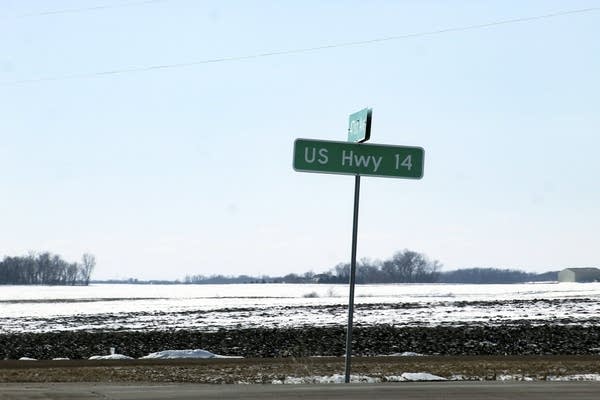 A sign reads "U.S. Highway 14" near a highway. 