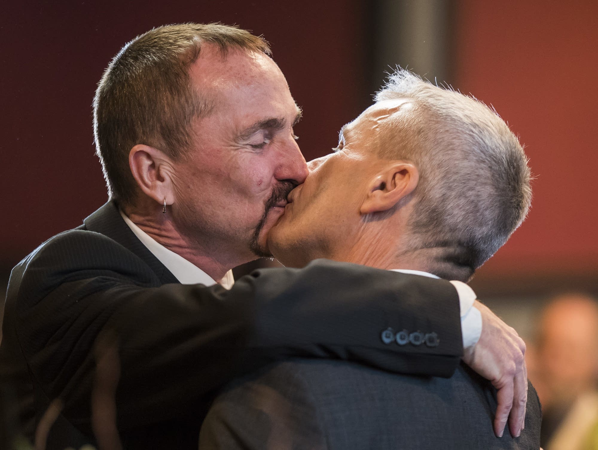 Germany's first gay couple to be legally married kiss