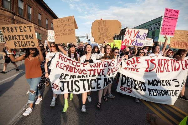 Protesters hold a banner