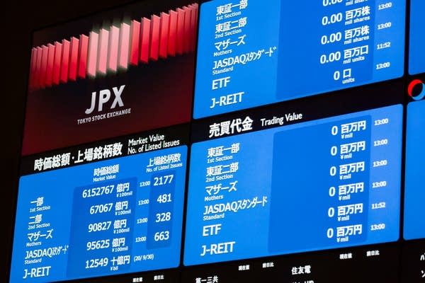 A stock board displays market indices at the Tokyo Stock Exchange. 
