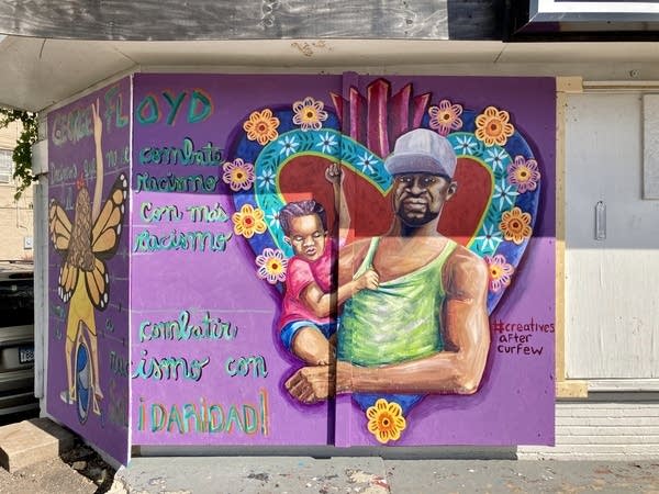 A mural is painted on a wall of a building.