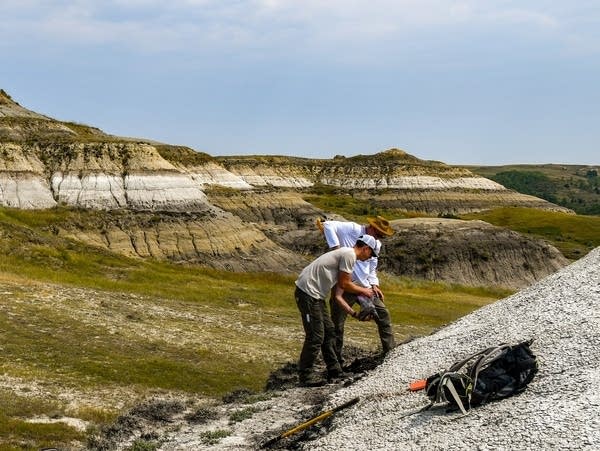 two men did in a rocky hillside 