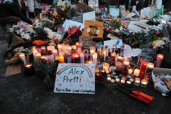Signs and candles decorate the ground.