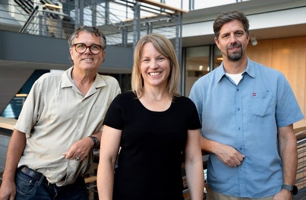 three people posing for a portrait