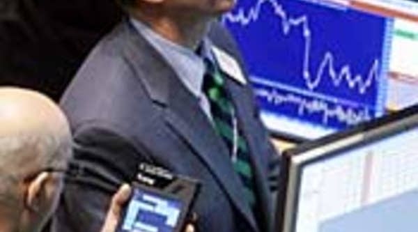 Traders work on the floor of the New York Stock Exchange after the Federal Reserve, in reaction to a severe downturn in worldwide stock markets and concern about a United States recession, reduced its interest rate today by three-quarters of a percentage point.