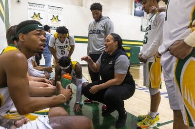 a basketball coach talks to her players