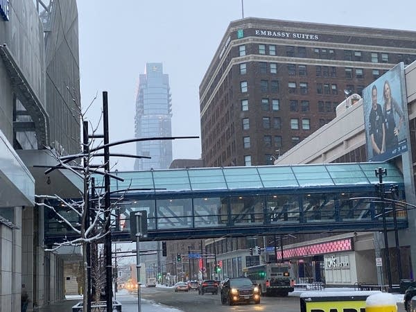 A view of Minneapolis buildings with cars on the road.